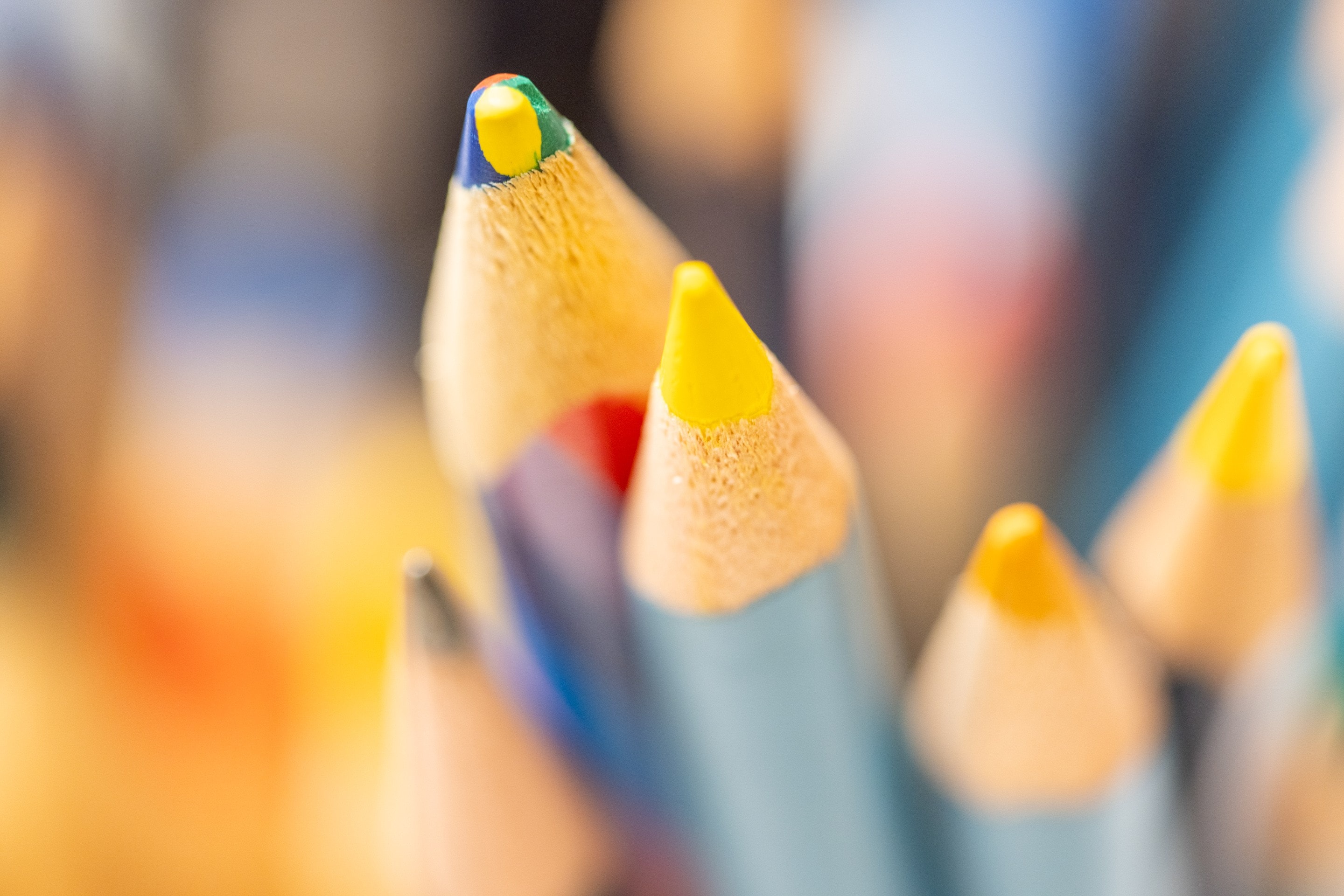 Macro photo of coloured pencil tips with narrow depth of field.