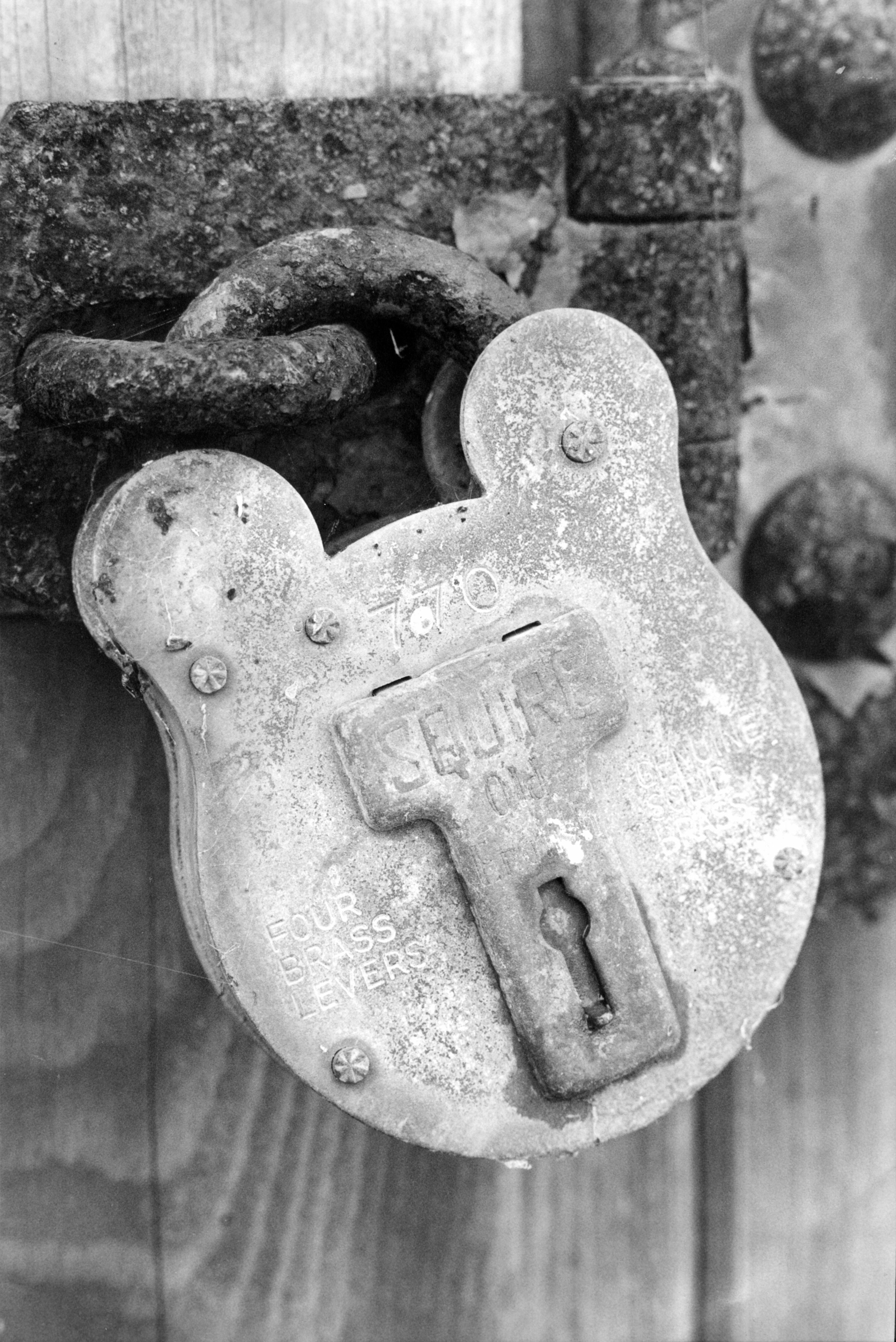 35mm film photograph of a padlock on a wooden door — Dorset, United Kingdom
