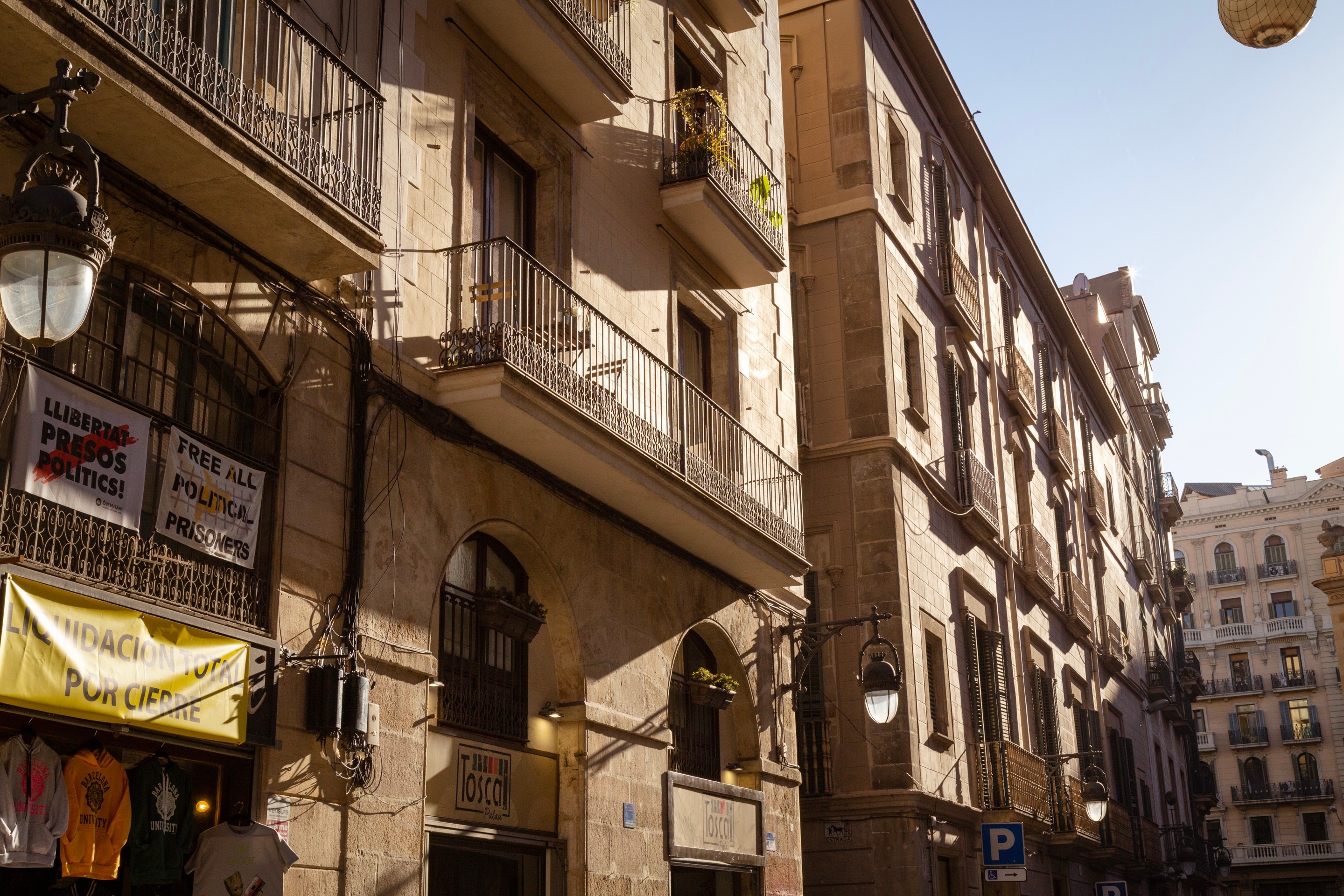 Afternoon sun casting shadows across old buildings in Barcelona.