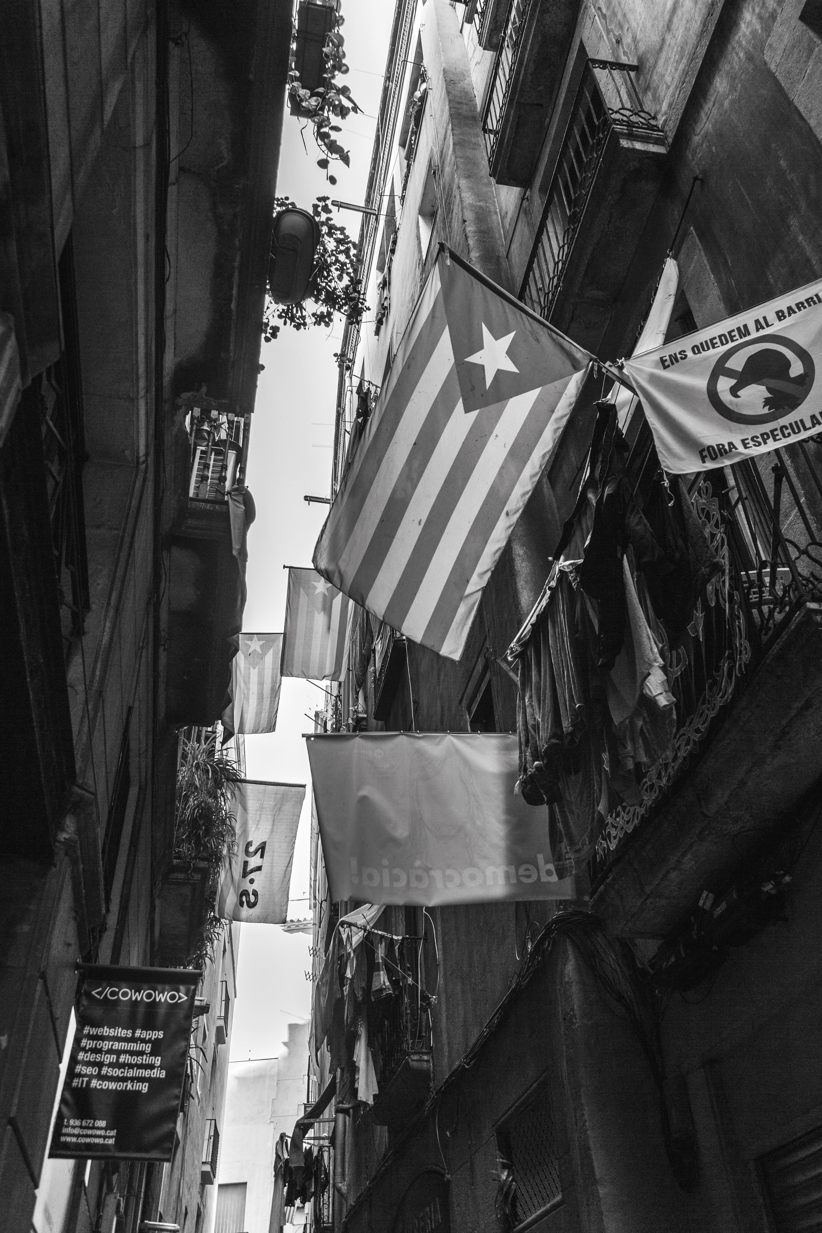 Catalan flags hanging from balconies along old narrow streets around Barcelona
