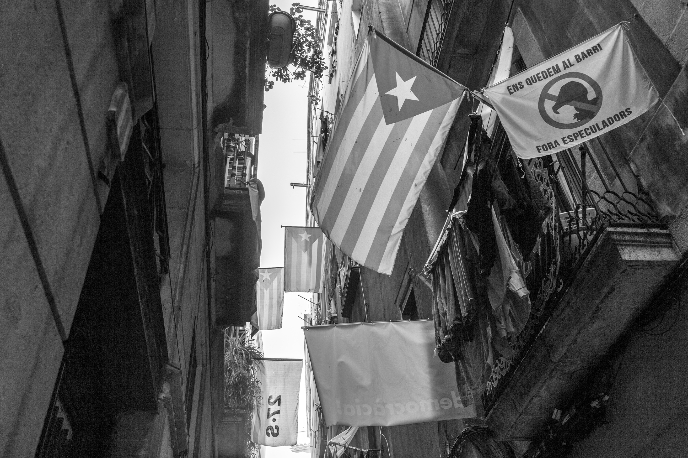 Catalan flags hanging from balconies along old narrow streets around Barcelona