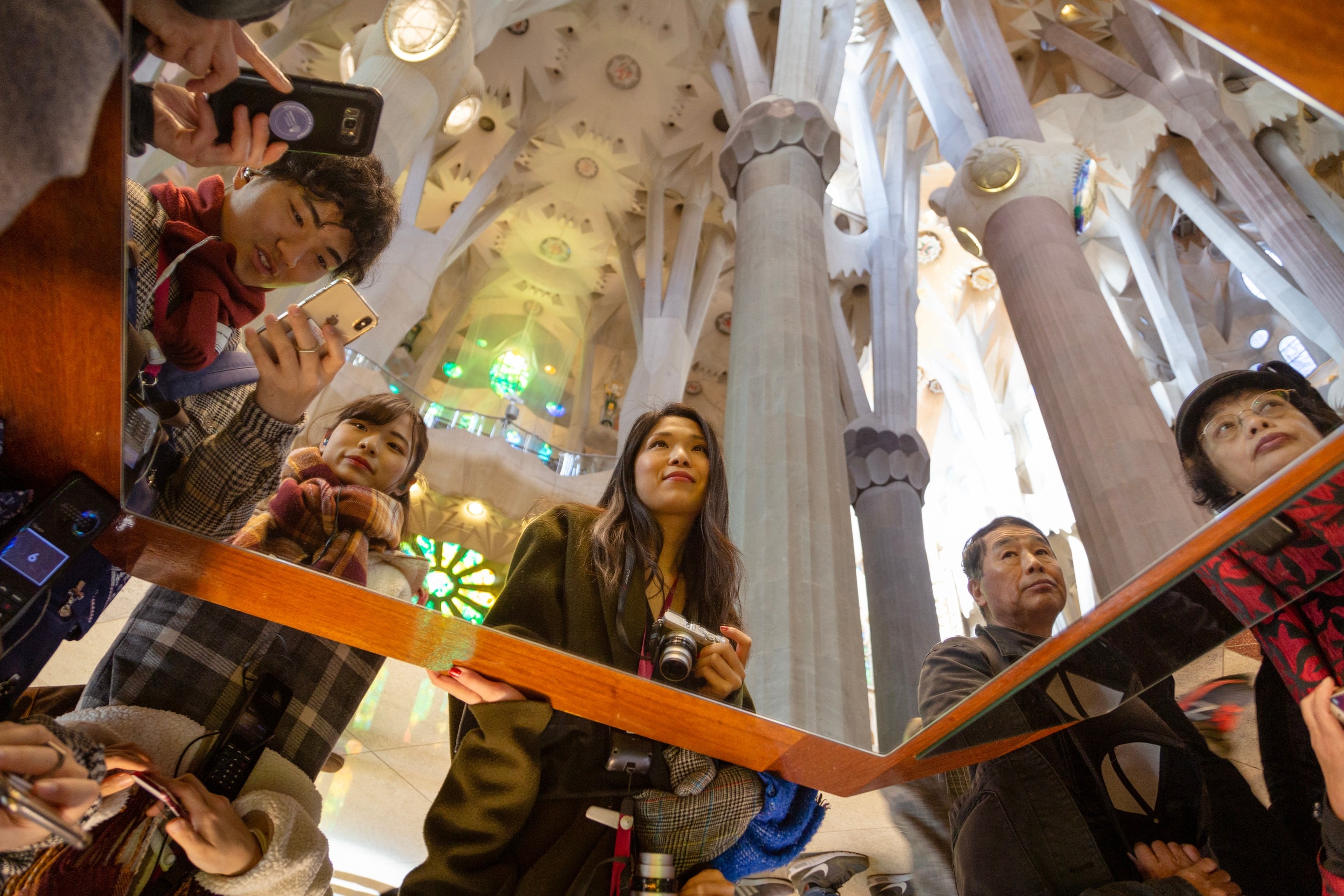 A viewing mirror placed to facilitate easier view of the roof, surrounded by people taking photos. La Sagrada Familia.