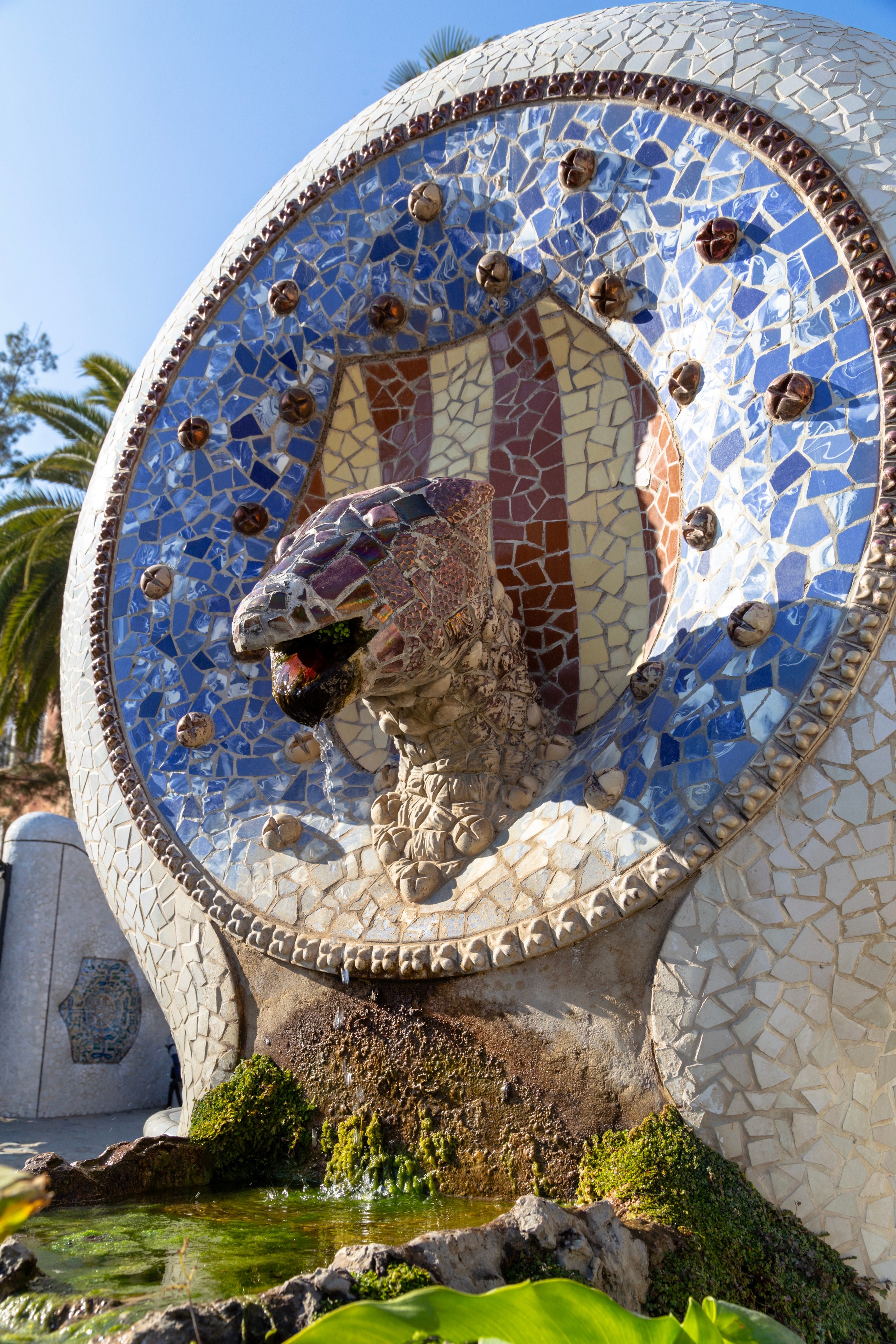 Intricate mosaic tiled large cat fountain at Parc Guell, Barcelona.