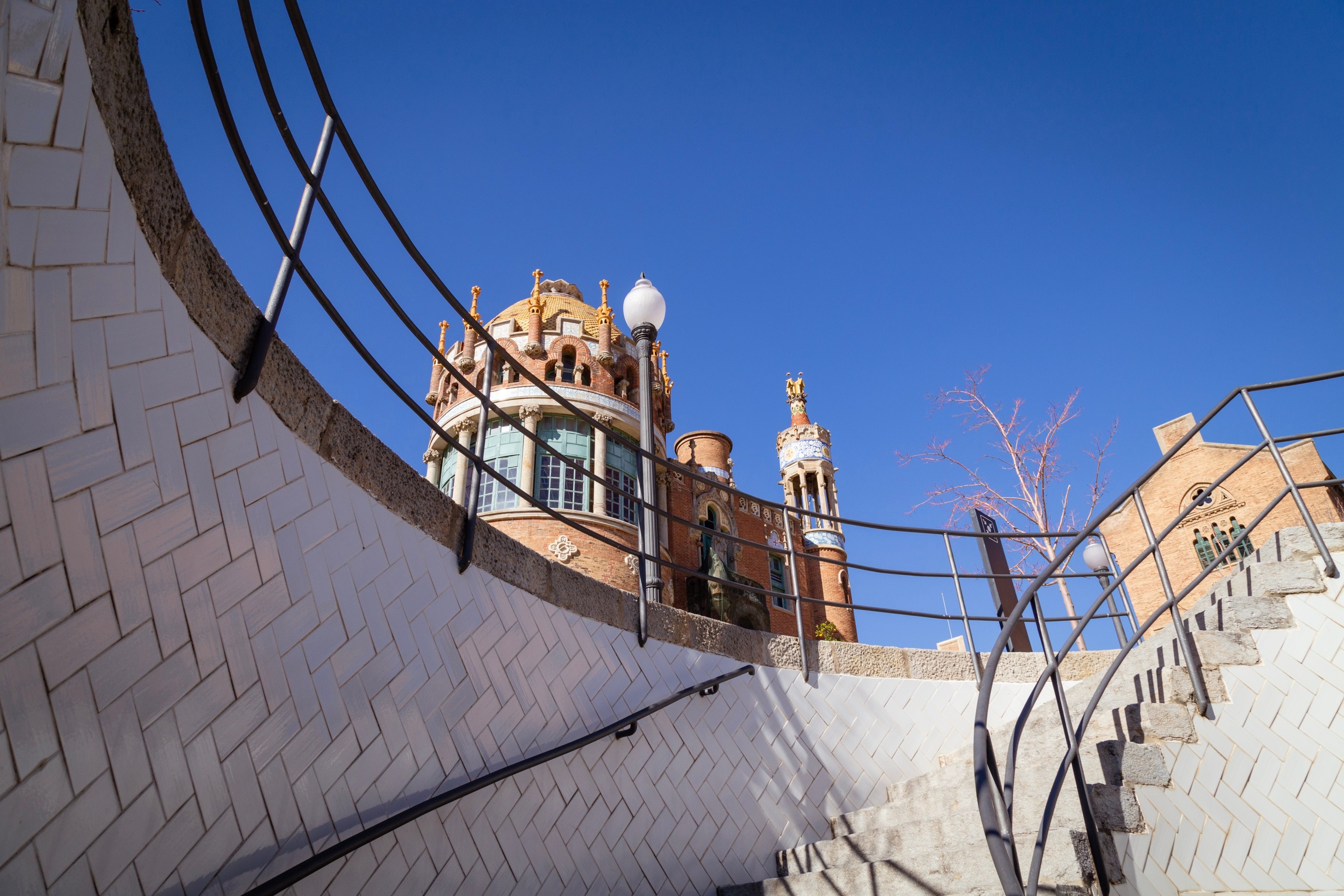 Tiled white round staircase at The Hospital de la Santa Creu i Sant Pau, Barcelona.