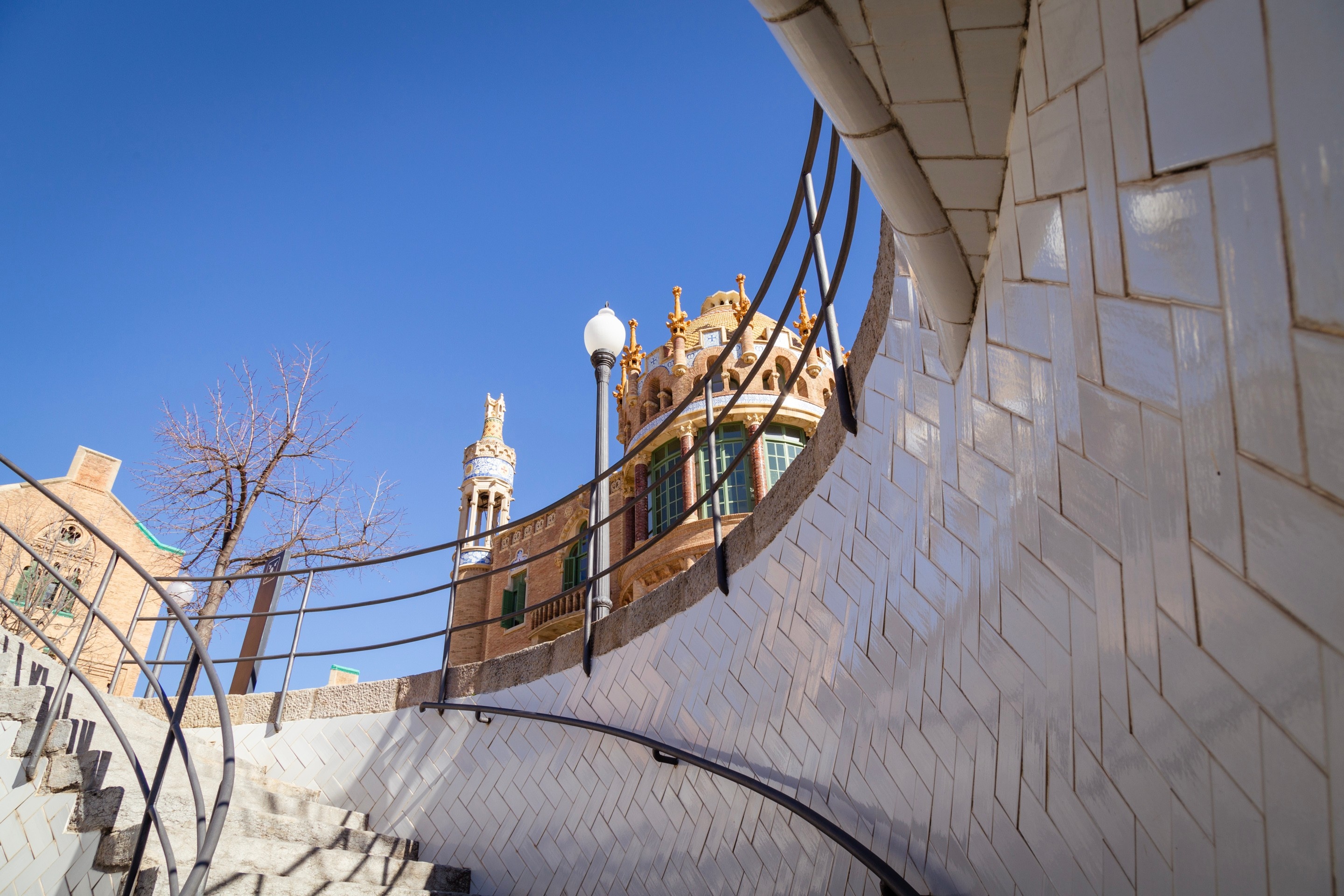 Tiled white round staircase at The Hospital de la Santa Creu i Sant Pau, Barcelona.
