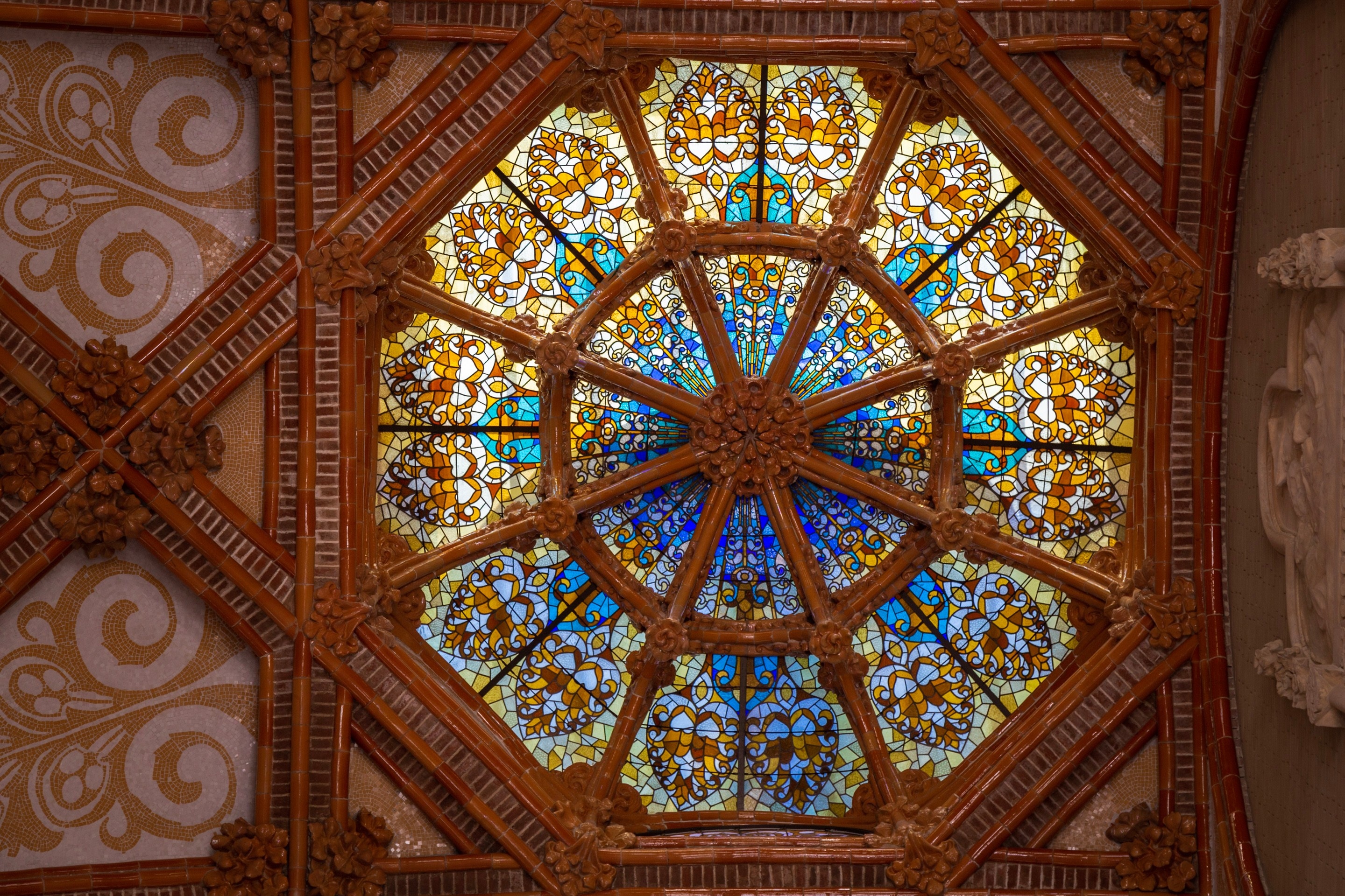 Intricate tiled dome roof and colourful stained glass dome window at The Hospital de la Santa Creu i Sant Pau, Barcelona.