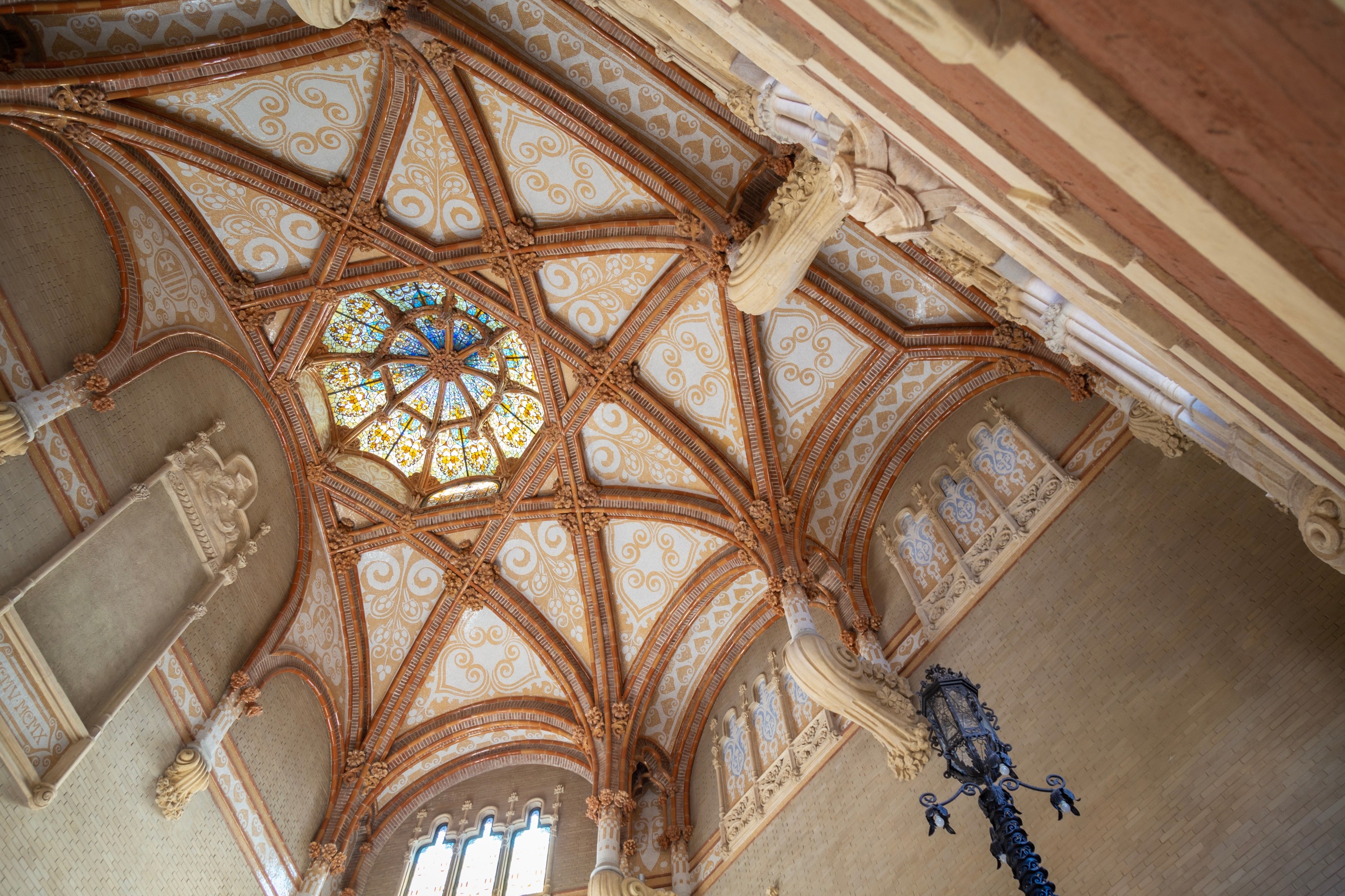 Intricate tiled dome roof and colourful stained glass dome window at The Hospital de la Santa Creu i Sant Pau, Barcelona.