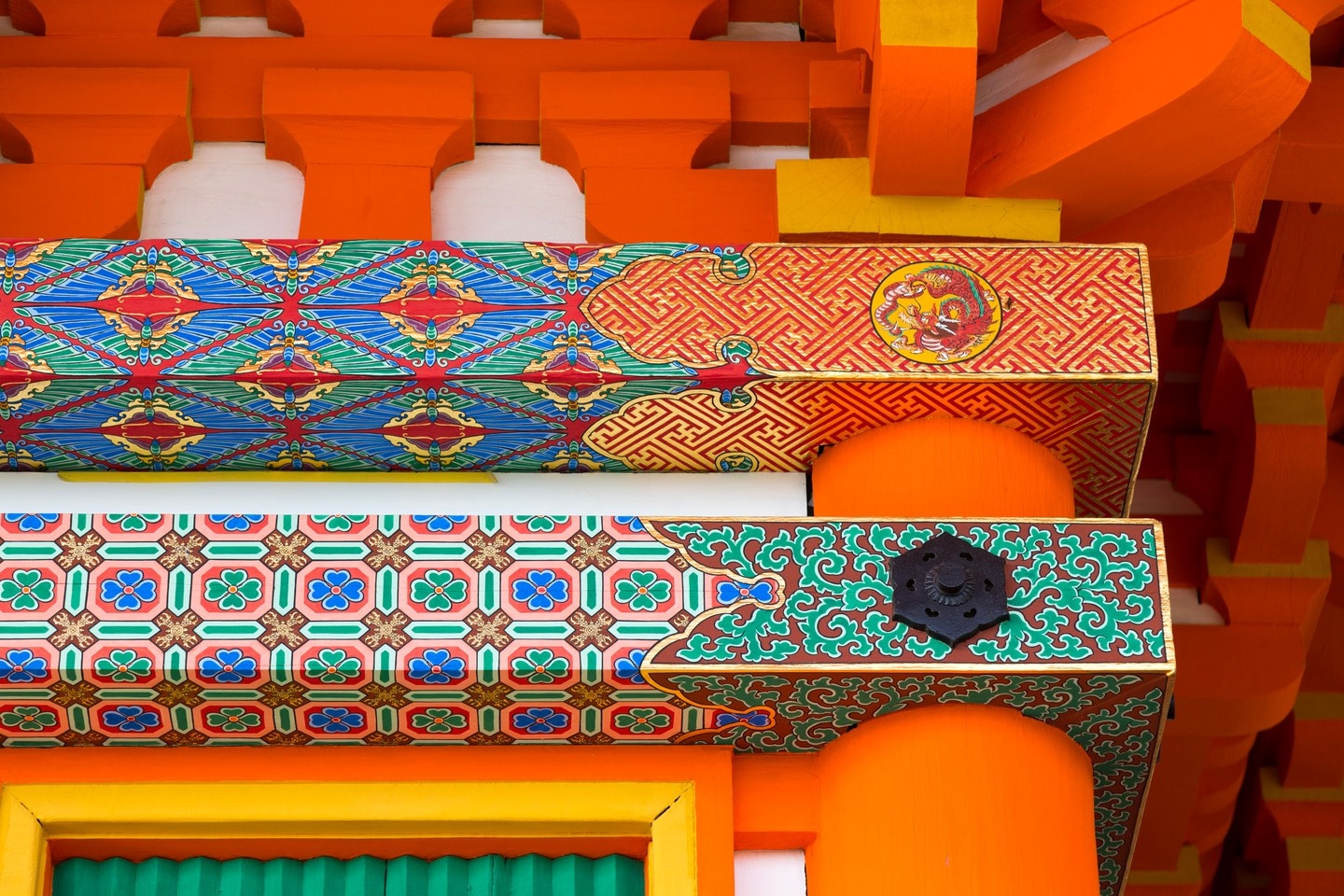 A detailed close-up image of the ornate patterns and paintwork on the three story pagoda at Kiyomizu-dera — Kyoto, Japan
