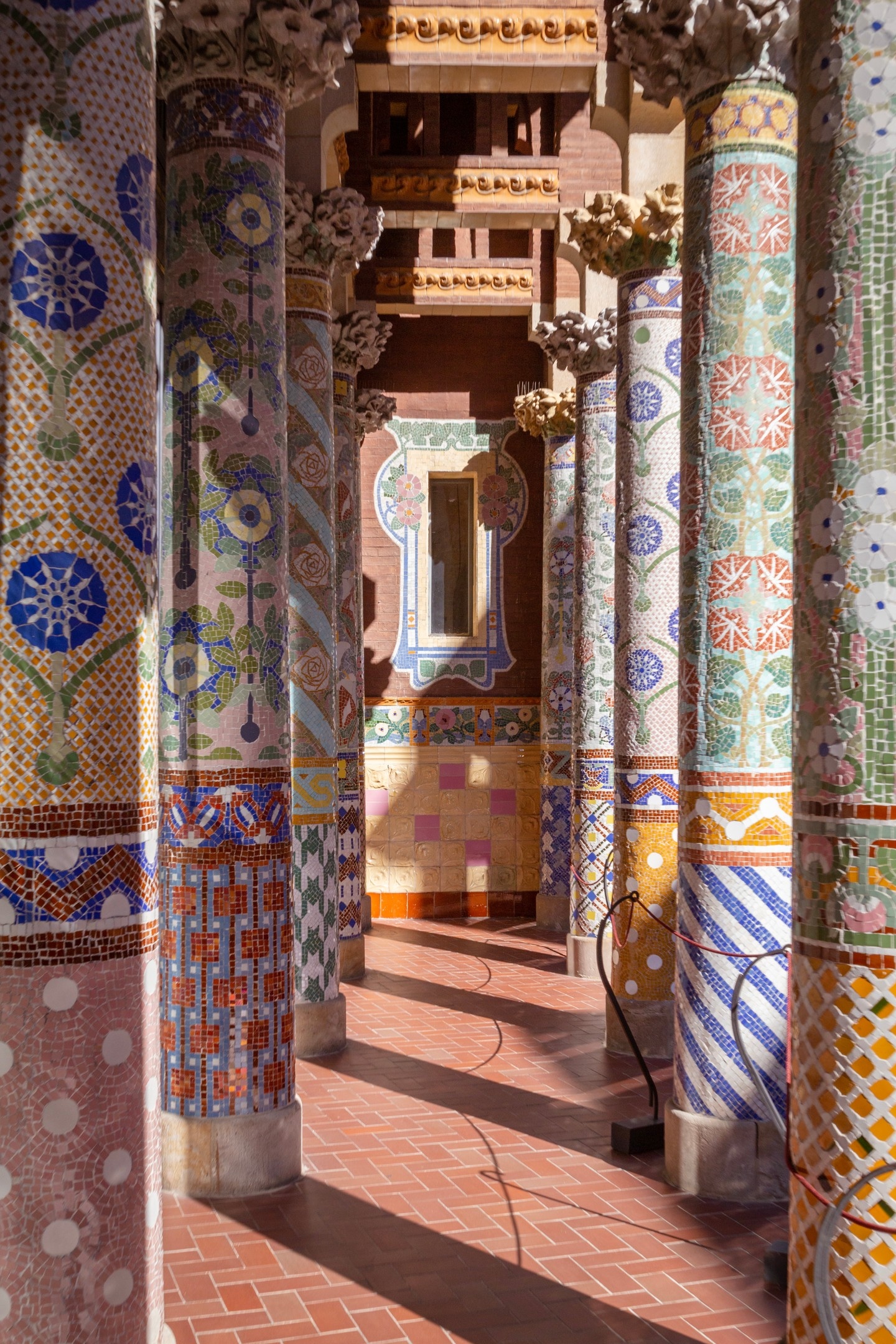 A tunnel of tiled mosaic pillars at Palau de la Música Catalana, Barcelona.