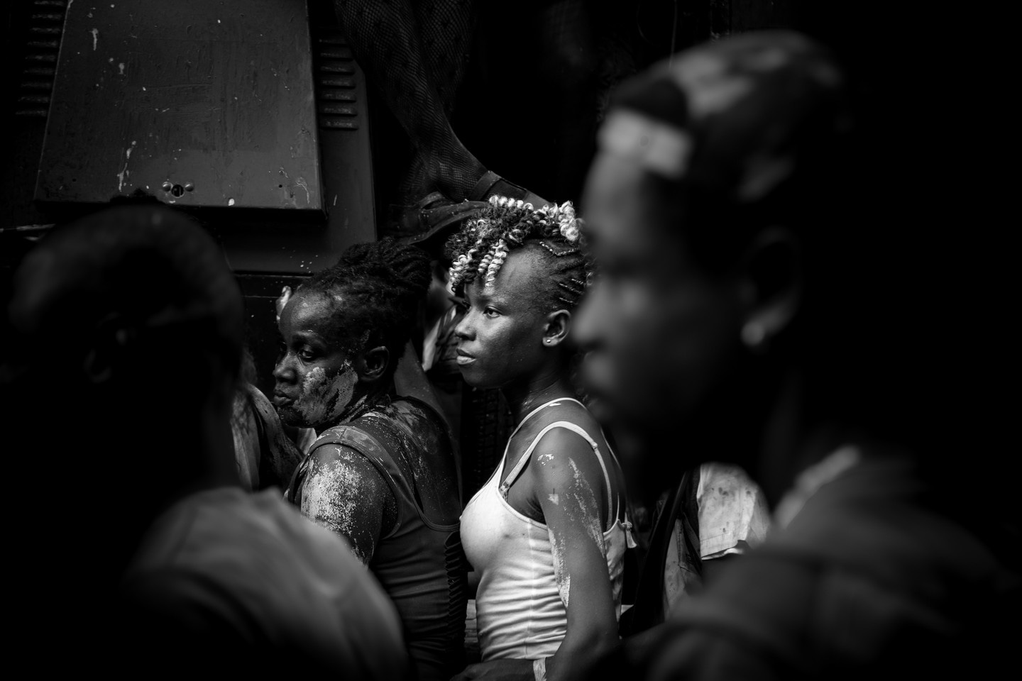 Black and white photo of exhausted party reveler covered in vibrant paints. Taken at Vincy Mas, the annual carnival in St. Vincent— Kingstown, Saint Vincent and the Grenadines