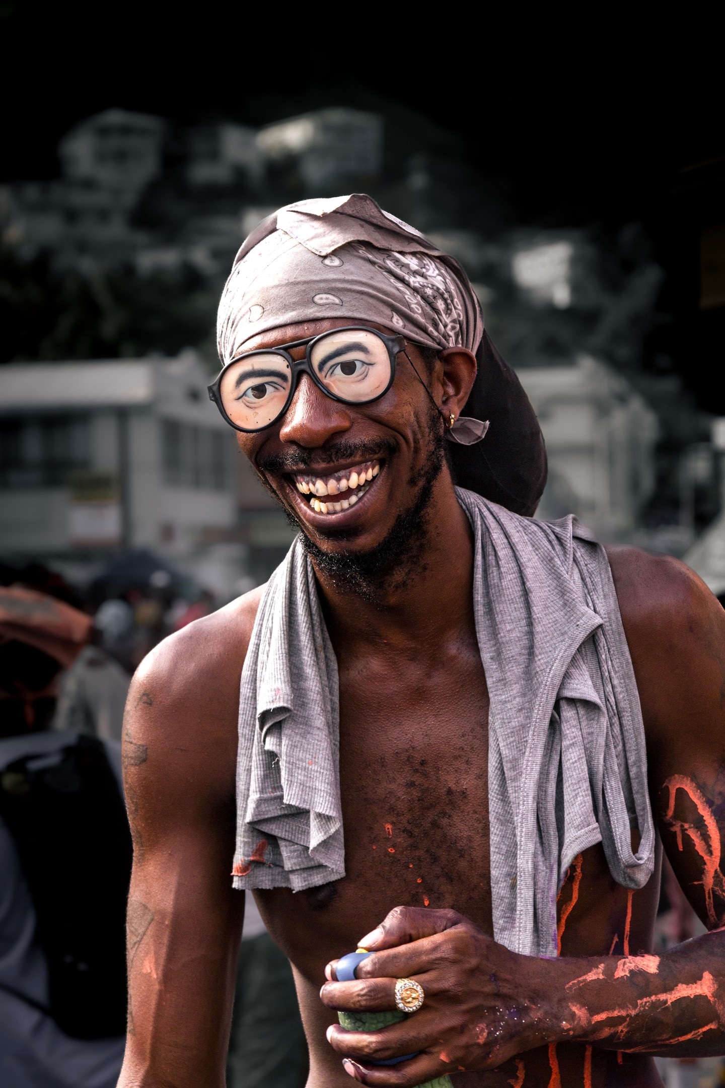 A very happy, smiling party reveller wearing party glasses, his body covered in vibrant paints makes for an infectiously happy scene in this image taken at Vincy Mas, the annual carnival in St. Vincent — Kingstown, Saint Vincent and the Grenadines