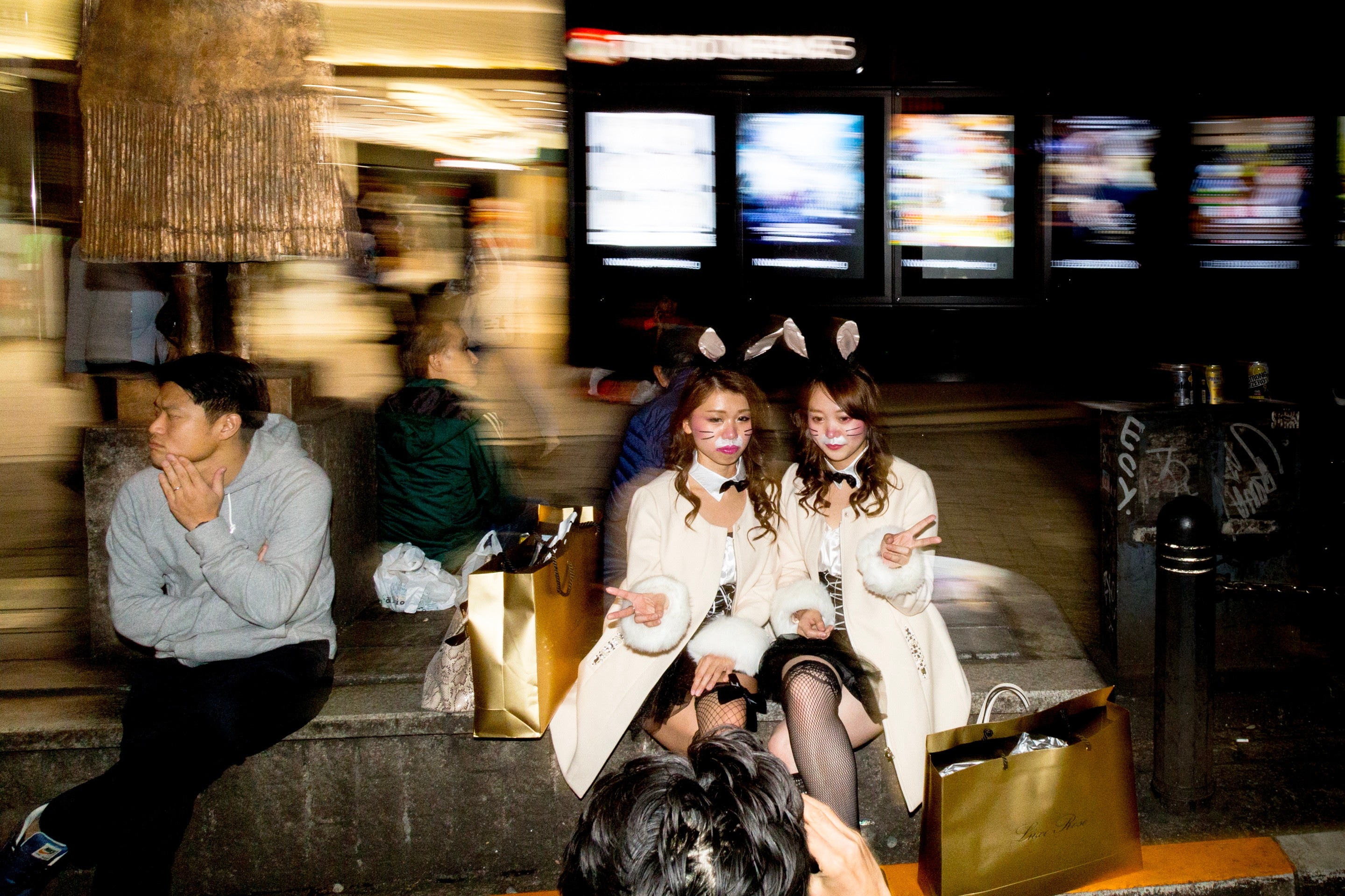 Two women with bunny ears being photographed at night in Shibuya to celebrate Halloween — Shibuya, Tokyo, Japan
