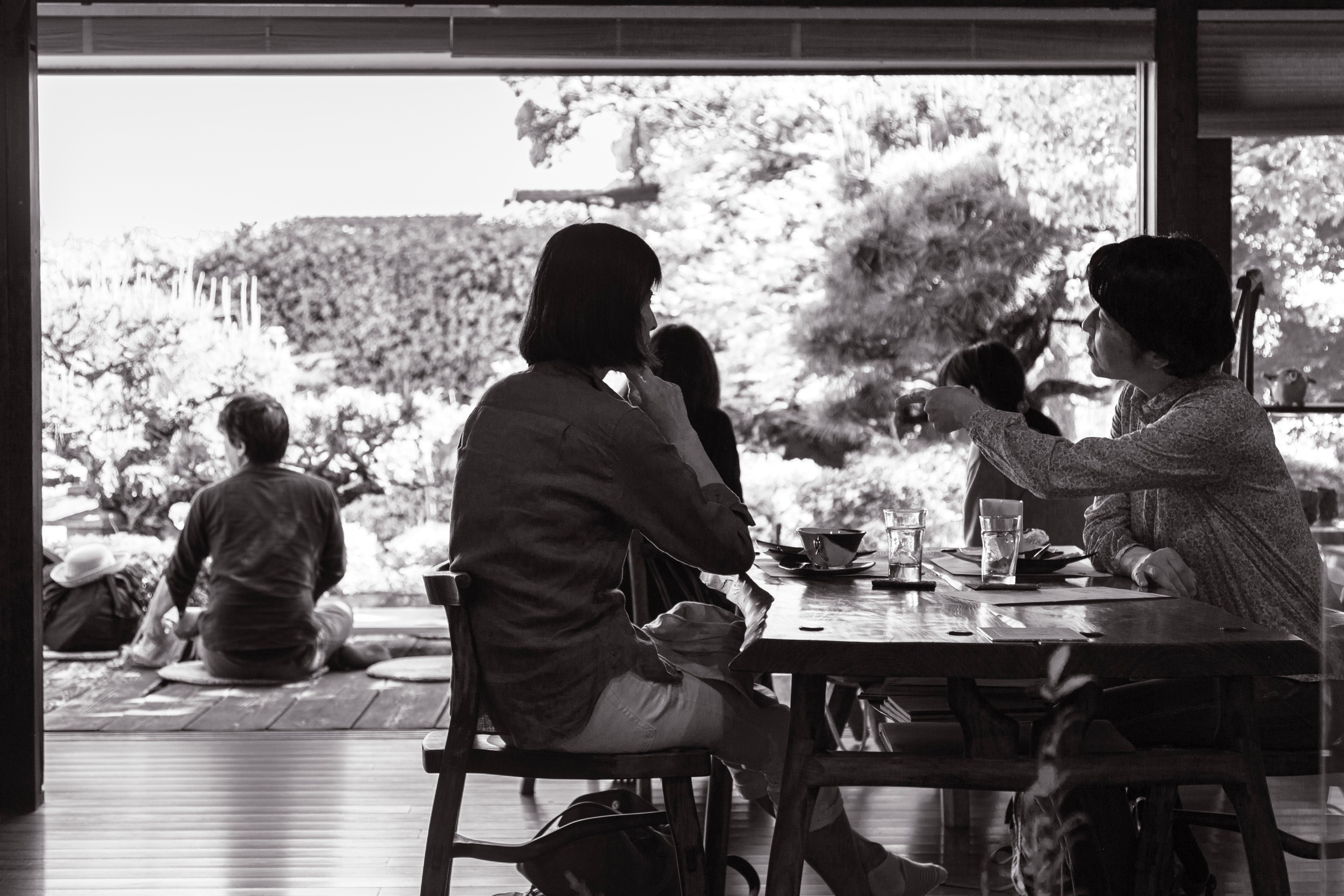 People talking inside a home cafe in Tomonoura Village, Hiroshima Prefecture.