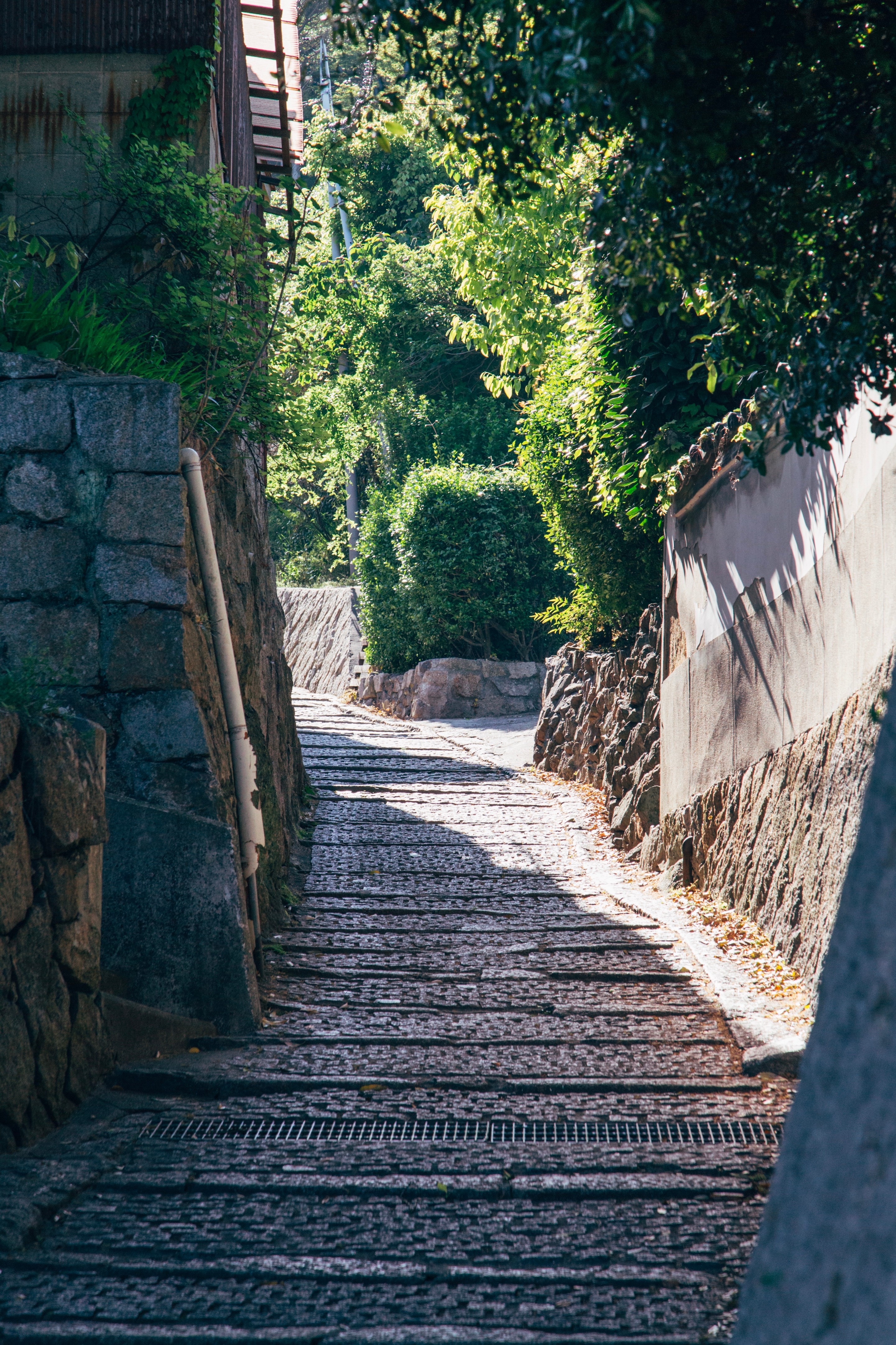 Looking up a hilly stone street in Tomonoura Village, Hiroshima Prefecture.