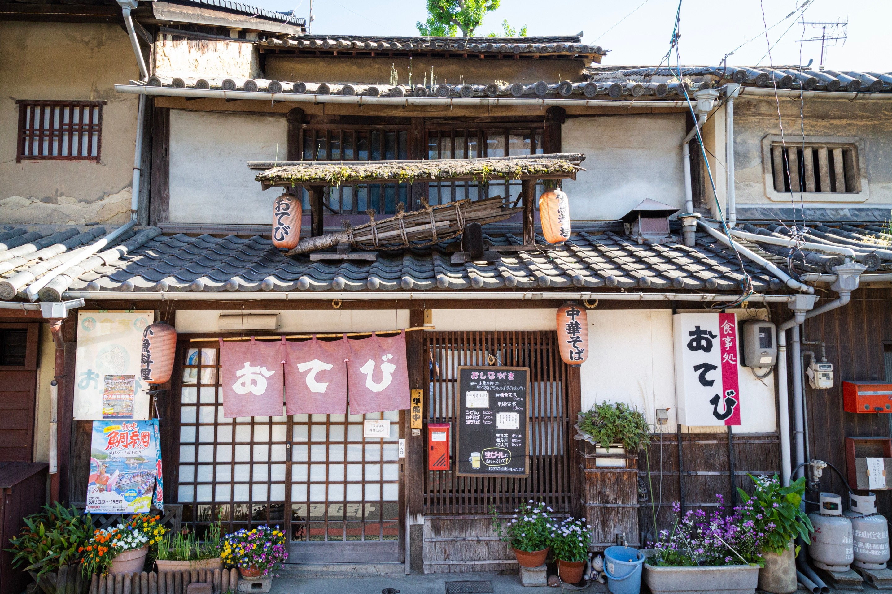 Izakaya bar during the day with flower pots outside the front. Tomonoura Village, Hiroshima Prefecture.
