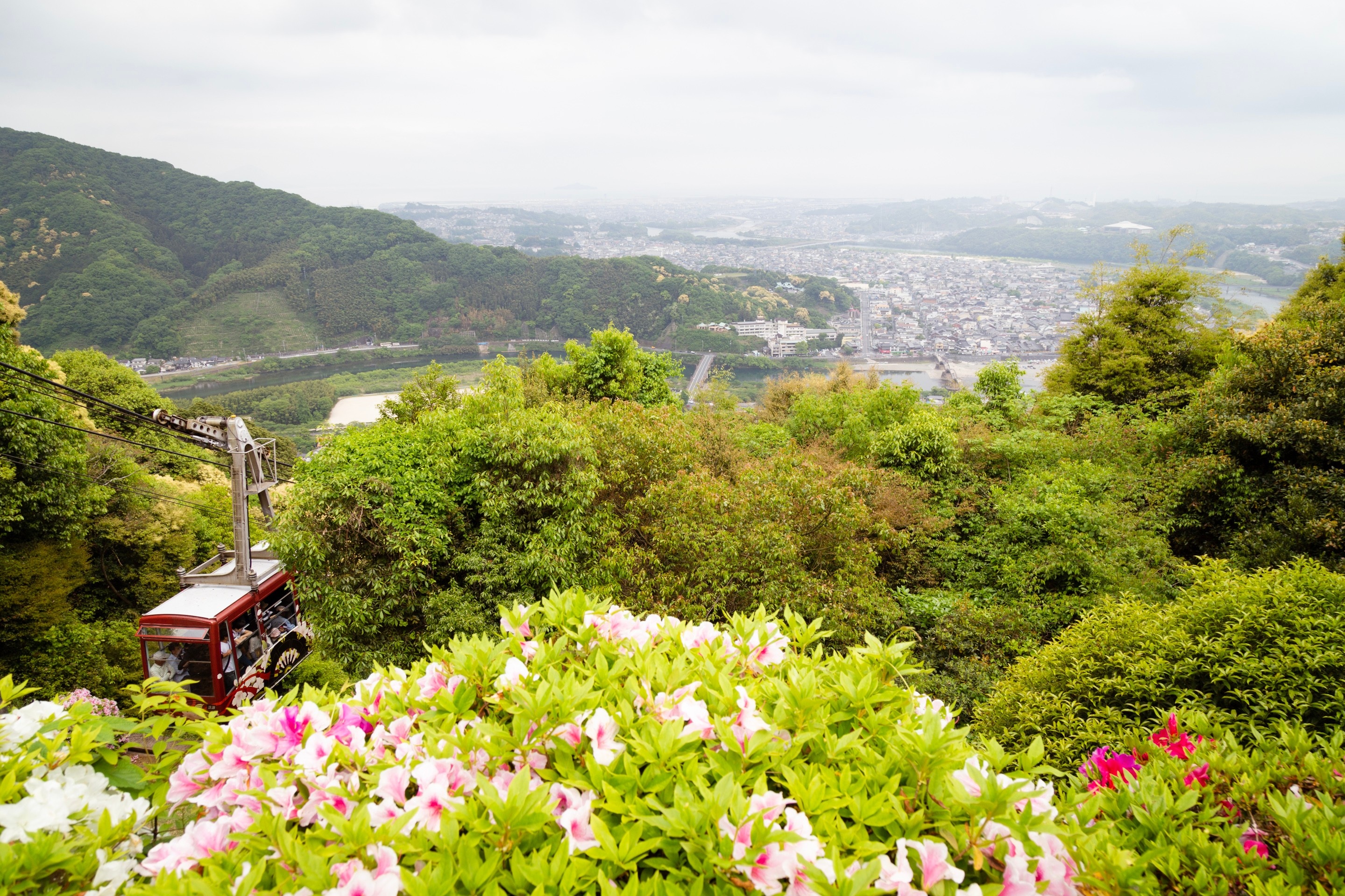 View from the hill above Iwakuni City, with a cable car in the foreground, looking down over the Kintaikyo Bridge and beyond. Yamaguchi Prefecture.