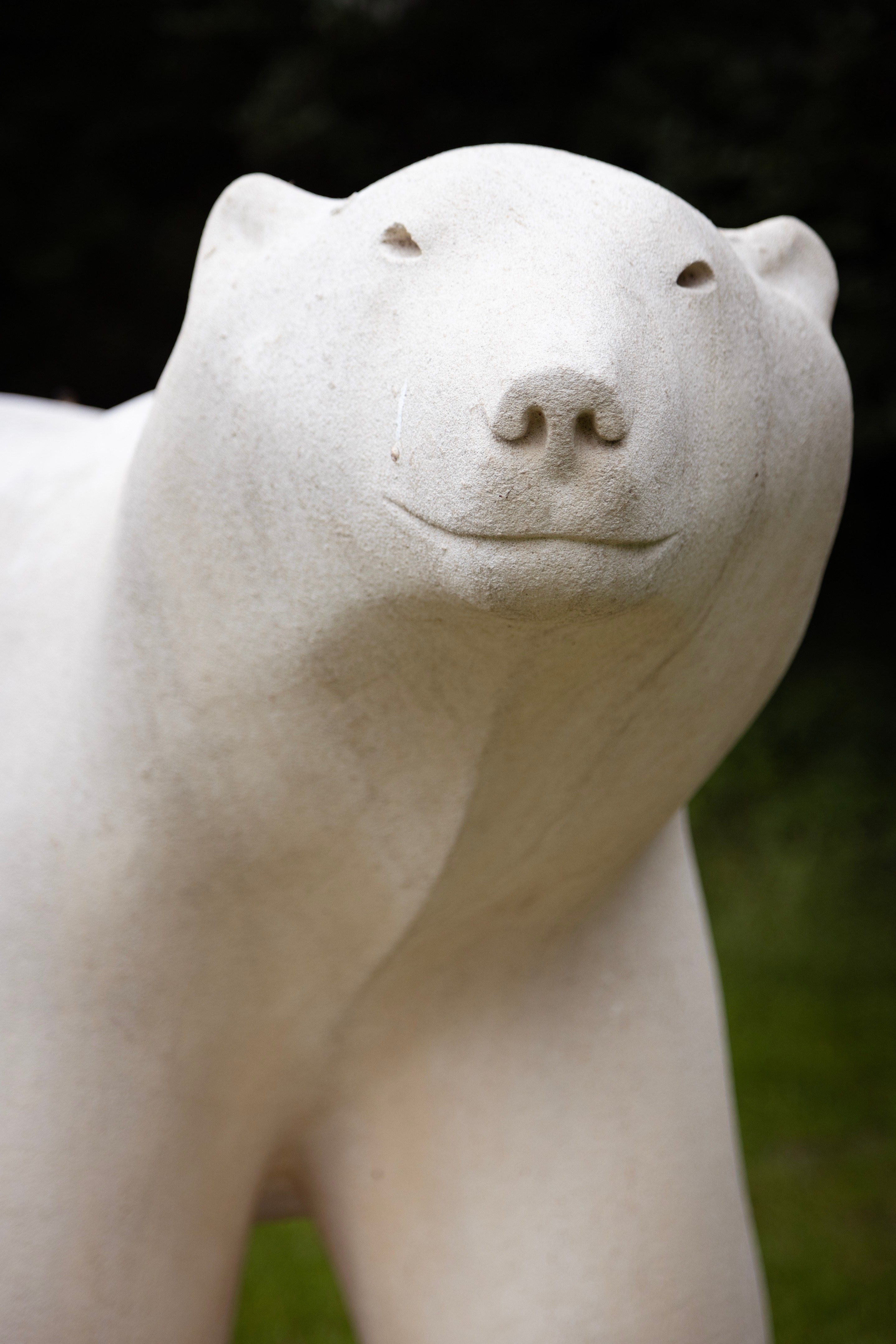 Close-up of a stone sculture of a polar bear, with a friendly face — Middelheim Museum, Antwerp, Belgium