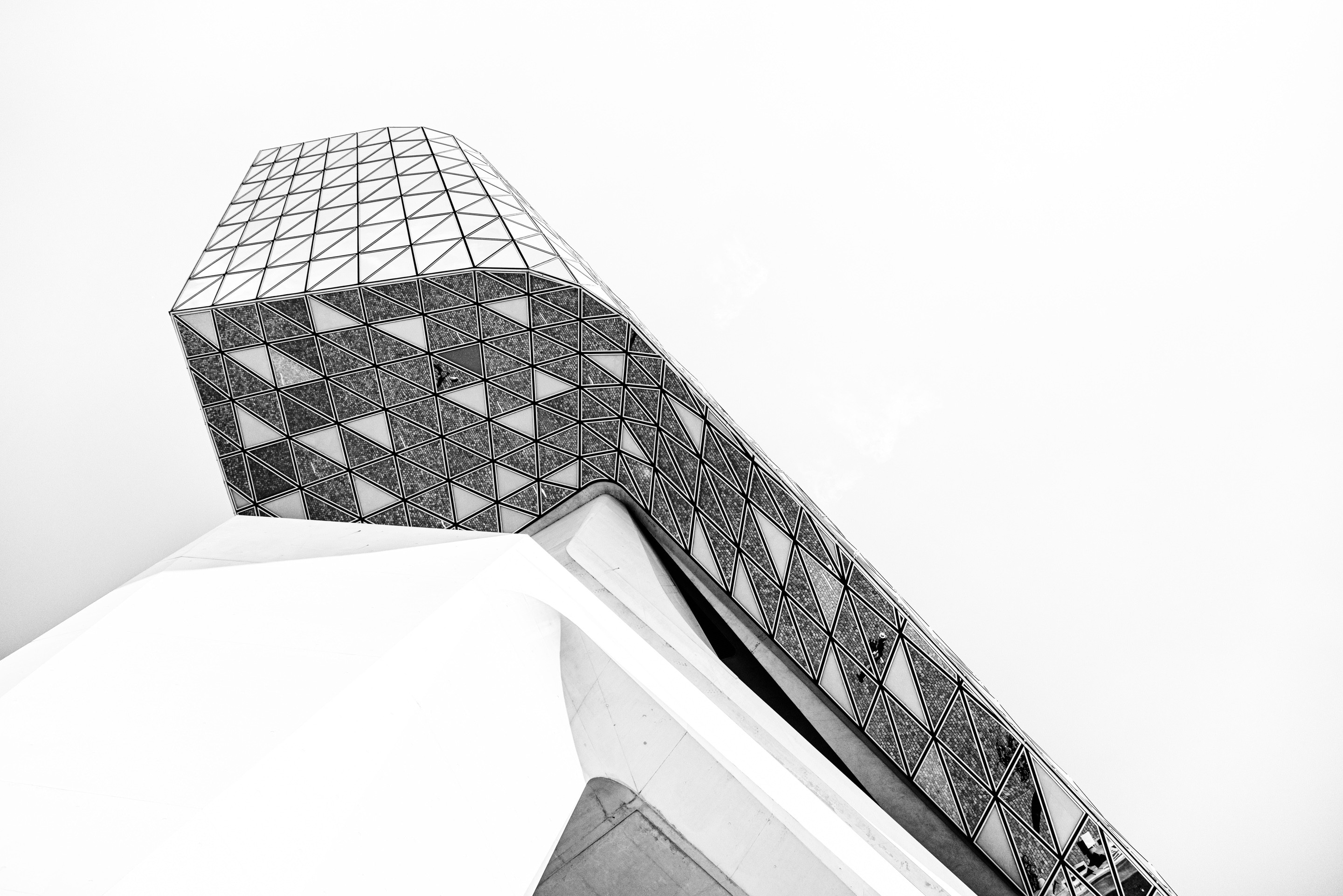 Looking up at the belly of the glass extension with the imposing concrete support column leading the eye up on The Port House by Zaha Hadid — Antwerp, Belgium 