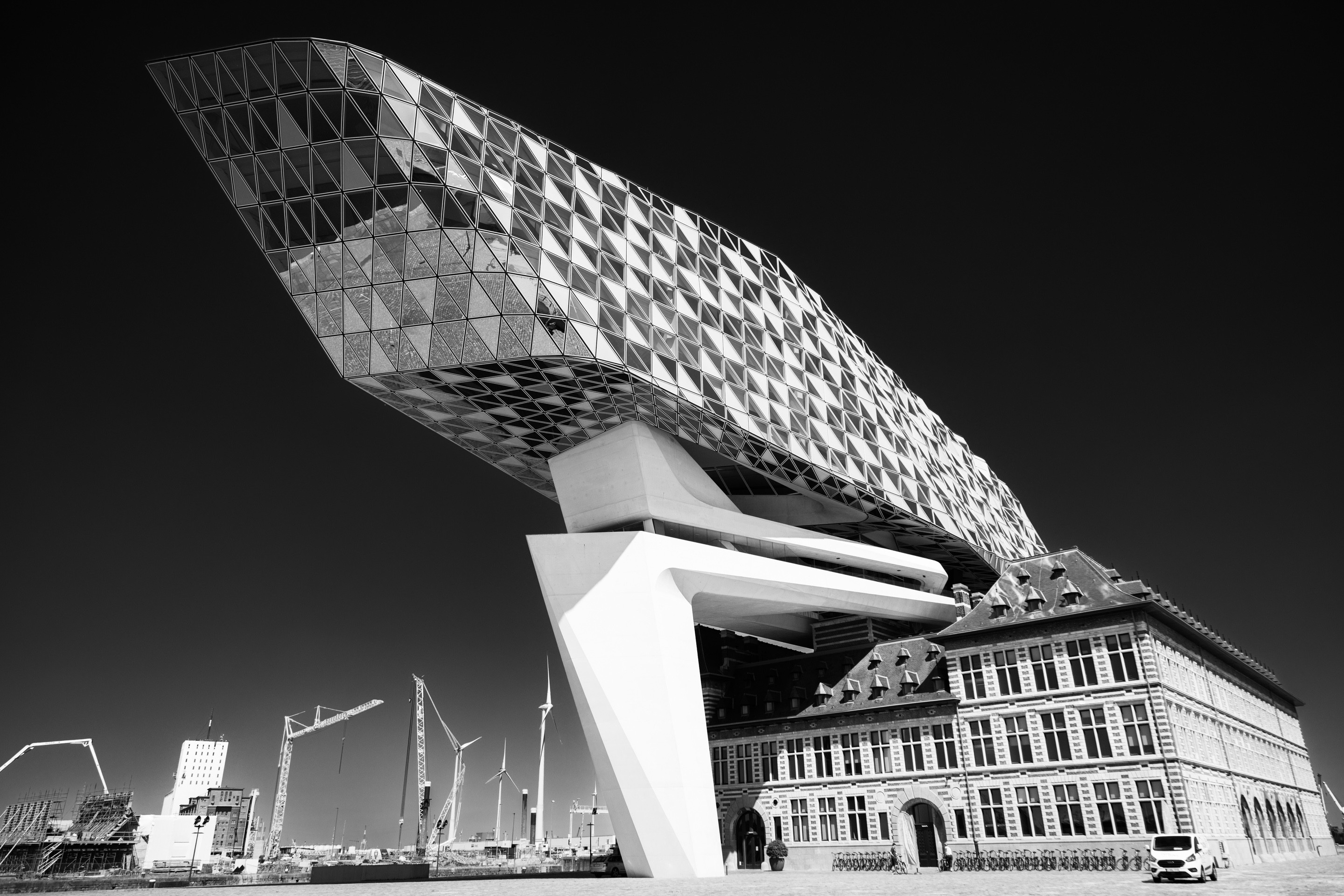Dramatic high contrast monochrome photo of the south elevation of the Port House by Zaha Hadid — Antwerp, Belgium