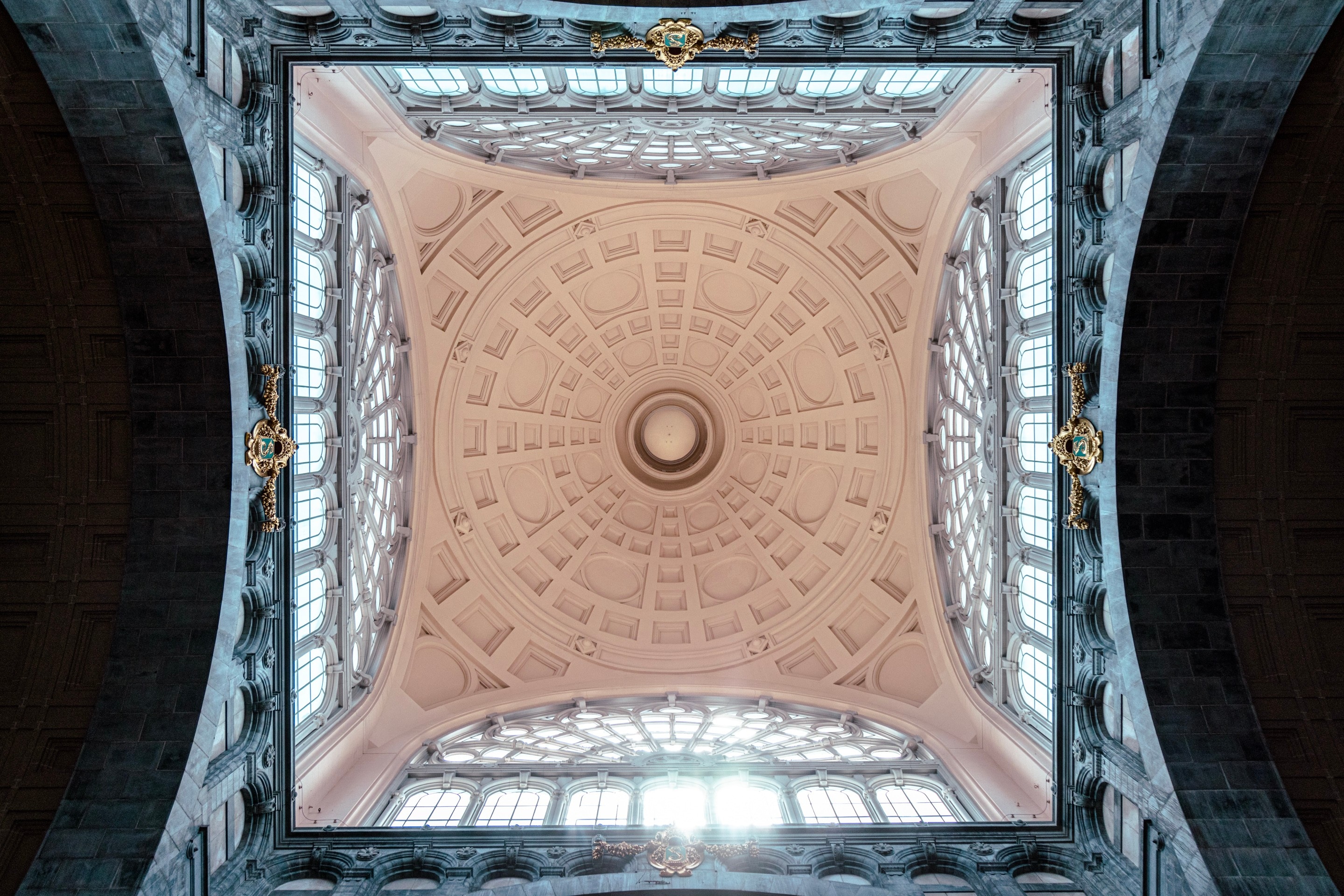 A symmetrial perspective looking directly up at the impressive iron dome on the Antwerp Cetral Station — Antwerp, Belgium