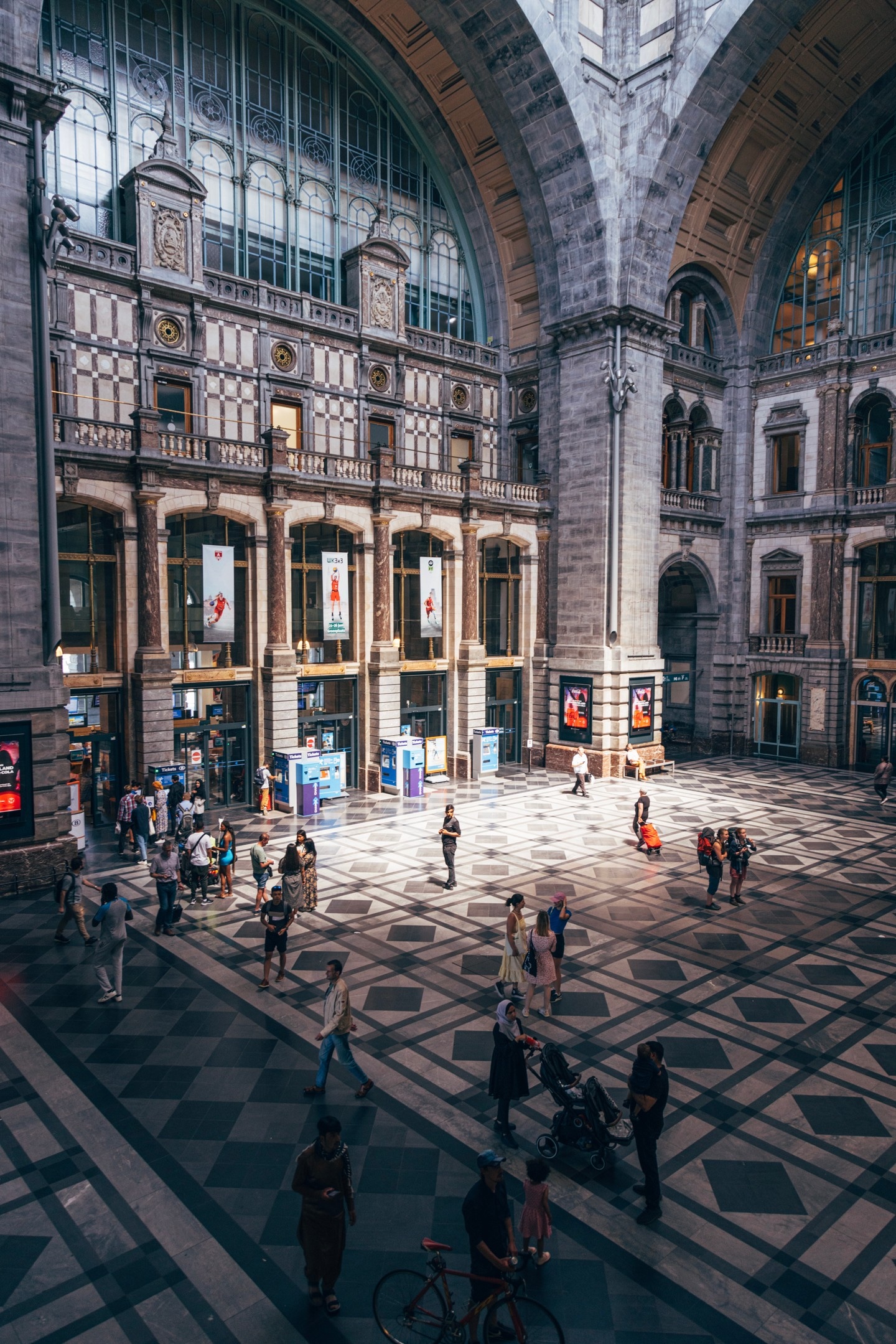 A shard of light illuminates passengers and the main atrirum of Antwerp Cetral Station — Antwerp, Belgium
