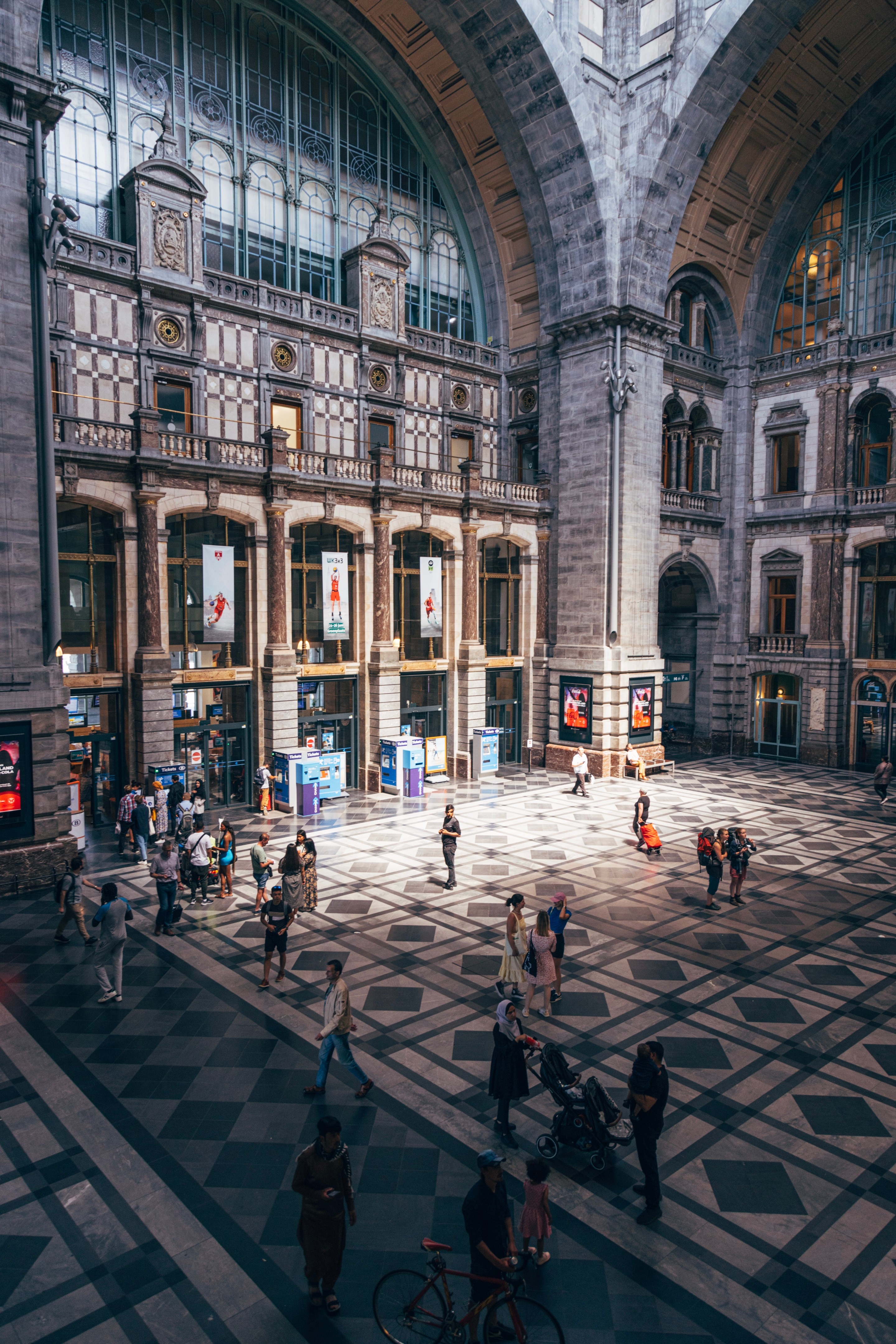A shard of light illuminates passengers and the main atrirum of Antwerp Cetral Station — Antwerp, Belgium