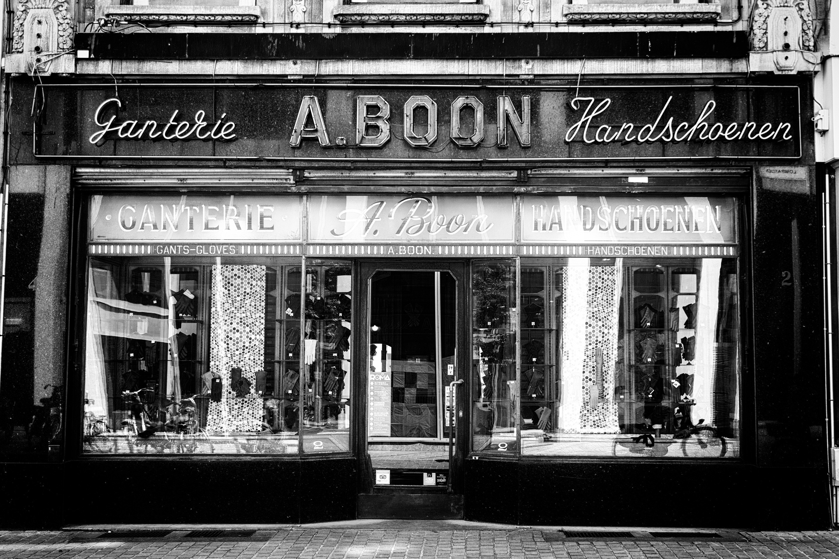 A black and white photo of an old glove and handkerchief shopfront — Antwerp City, Belgium