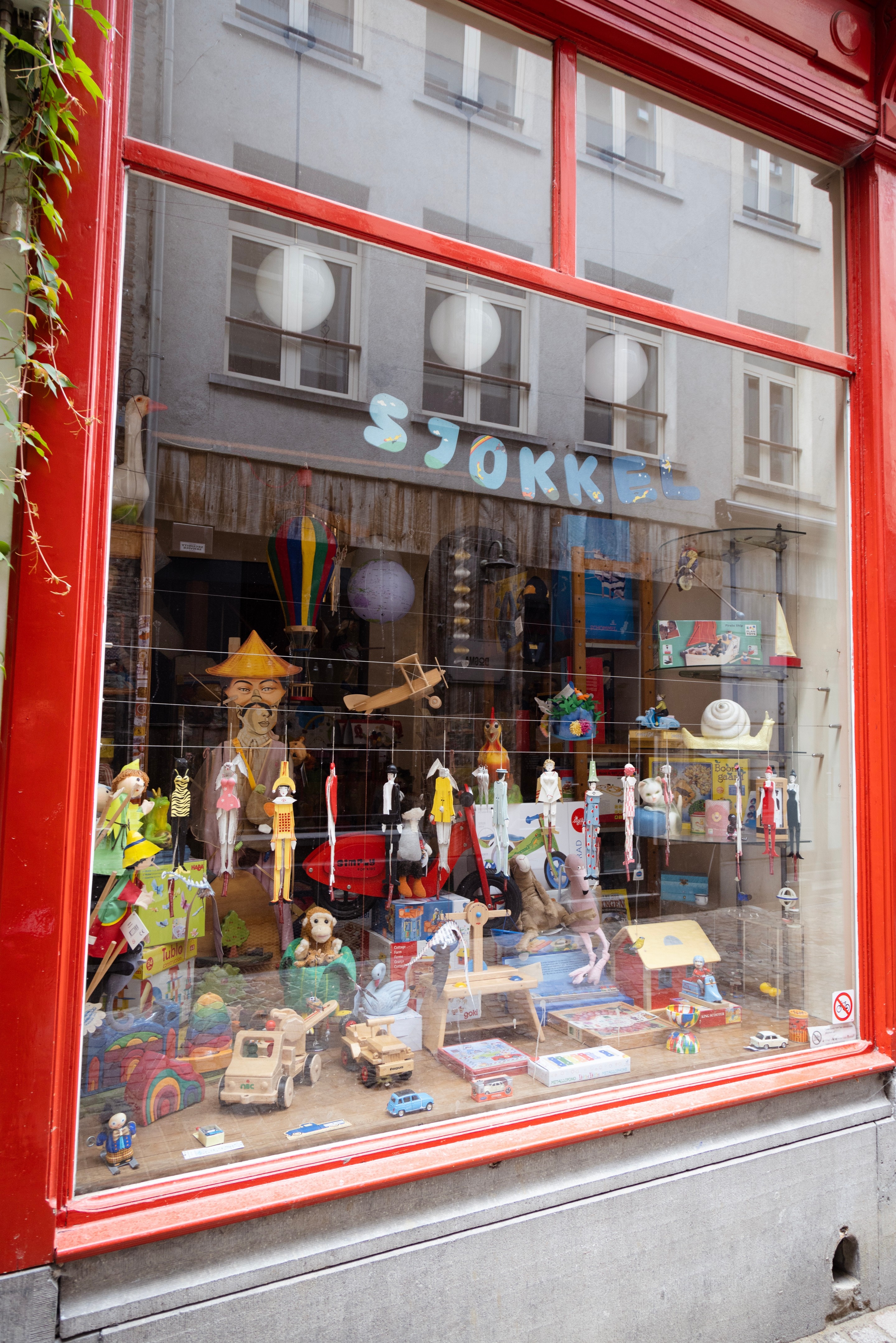 A shop windows displays a welcoming rance of wooden toys — Antwerp City, Belgium
