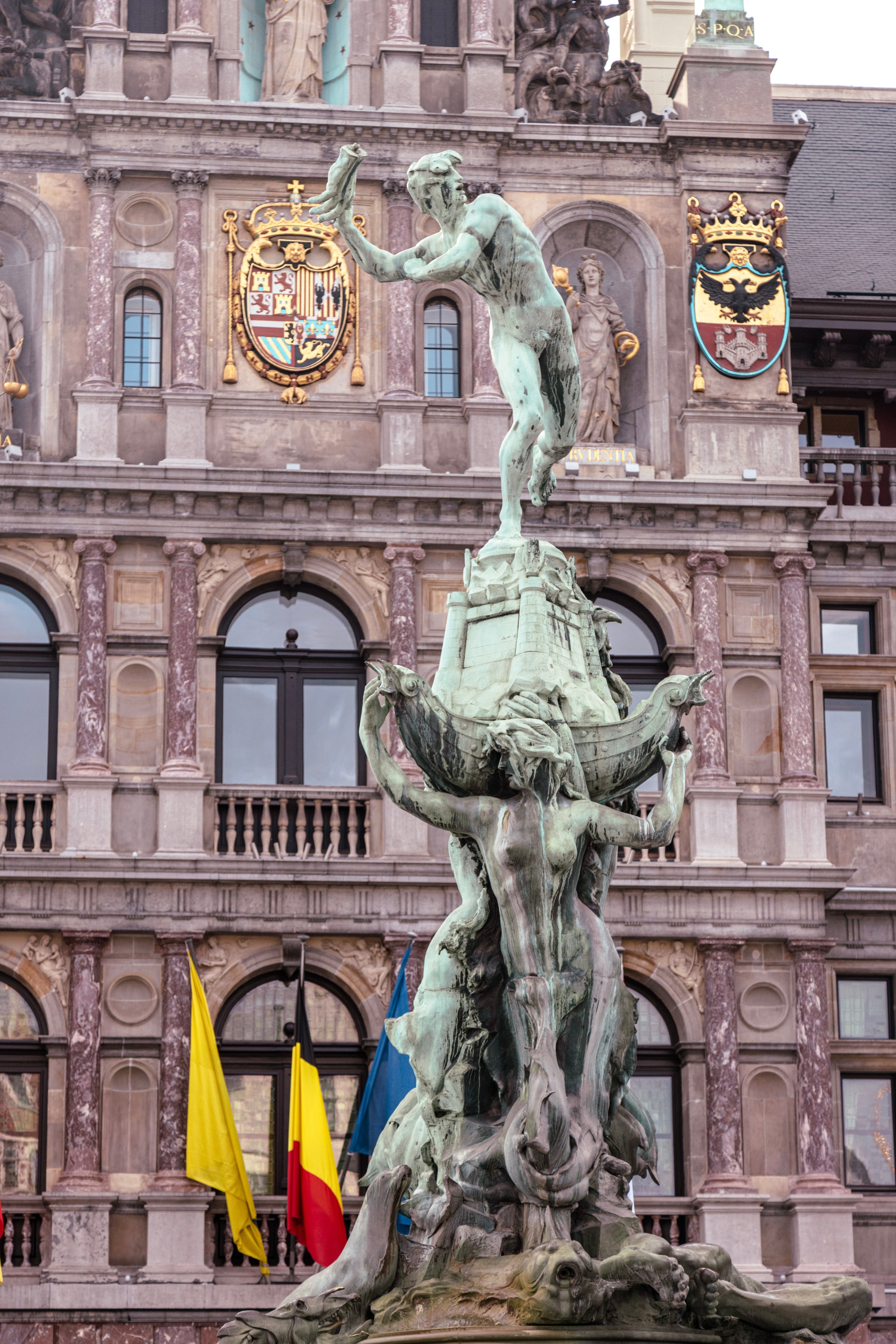 In the foreground is the Brabo Fountain with the City Hall in the background — Main Square, Antwerp City, Belgium