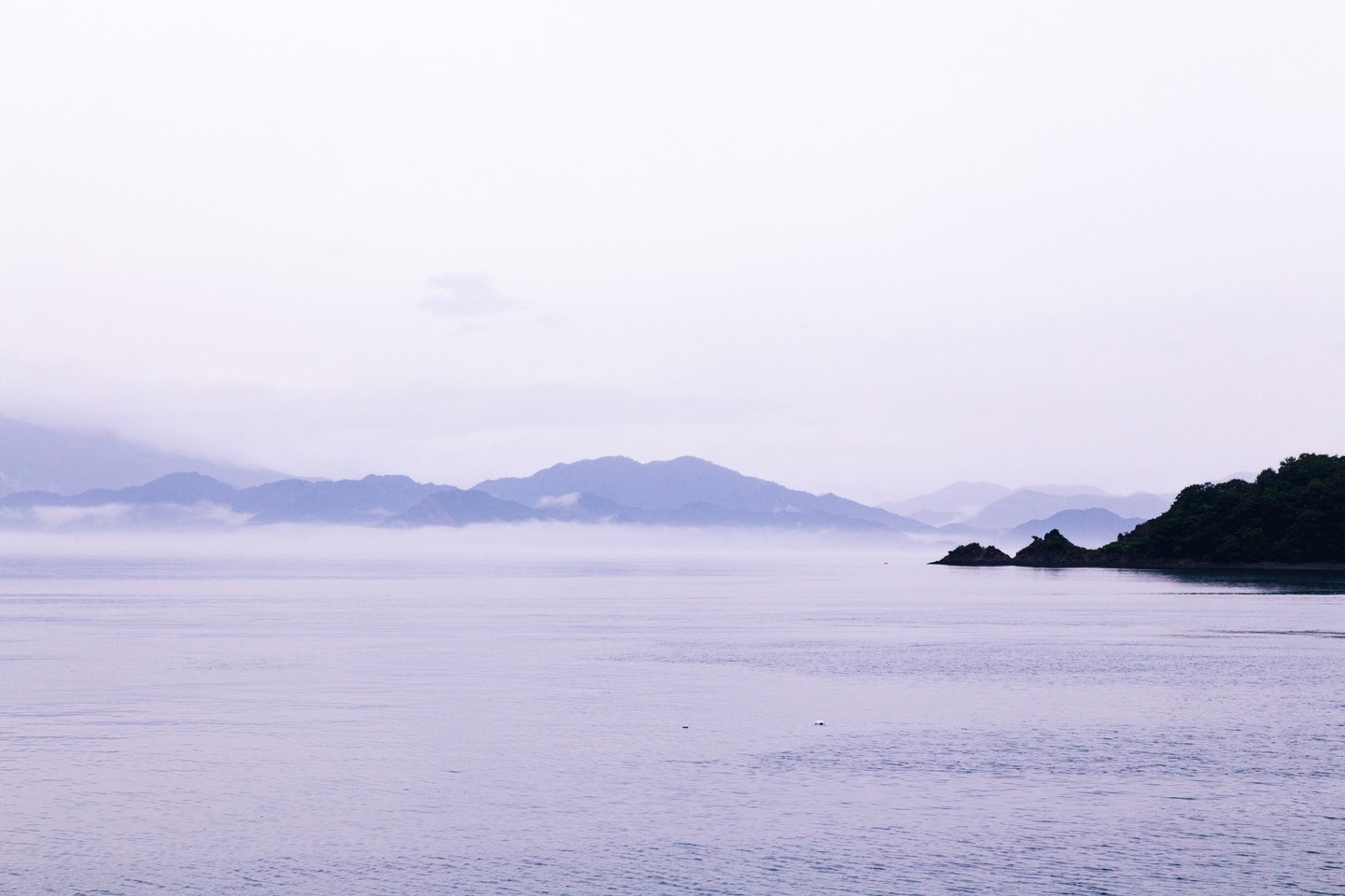 A lilac-washed seascape scene taken from Osaki Shimojima Island, looking out over veiled layers of mountainous islands — Geiyo Region, Hiroshima Prefecture.